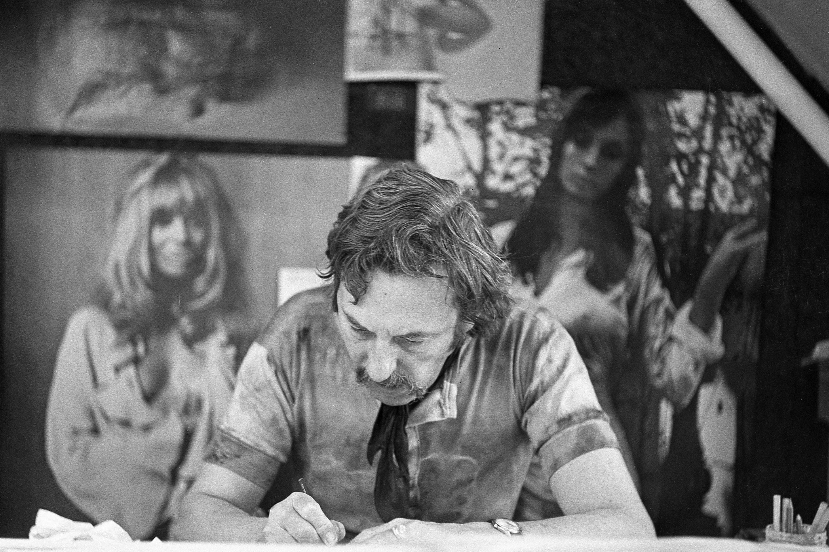 Bob Godfrey at his desk, surrounded by production artwork