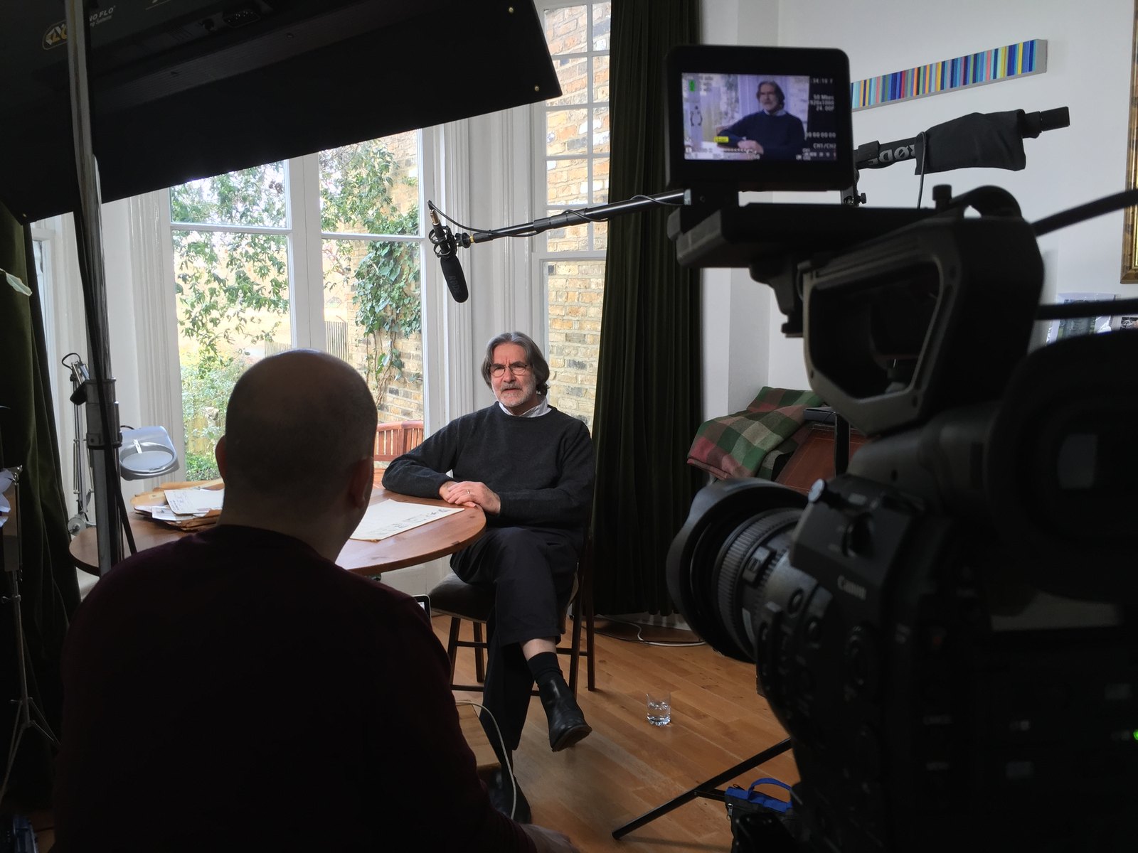 An interview being filmed for the anniversary documentary, seen from behind the camera.