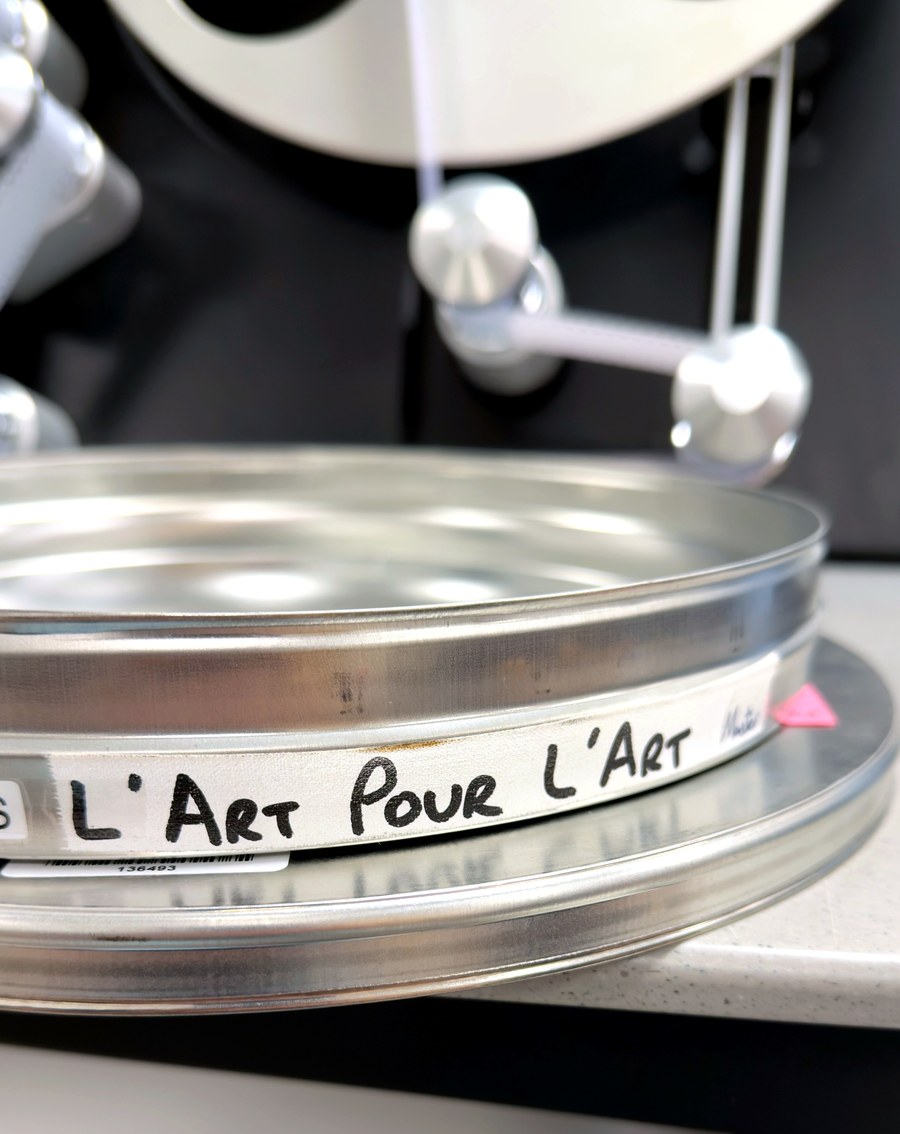 The L'art Pour L'art film reel, labelled by hand, on the scanner